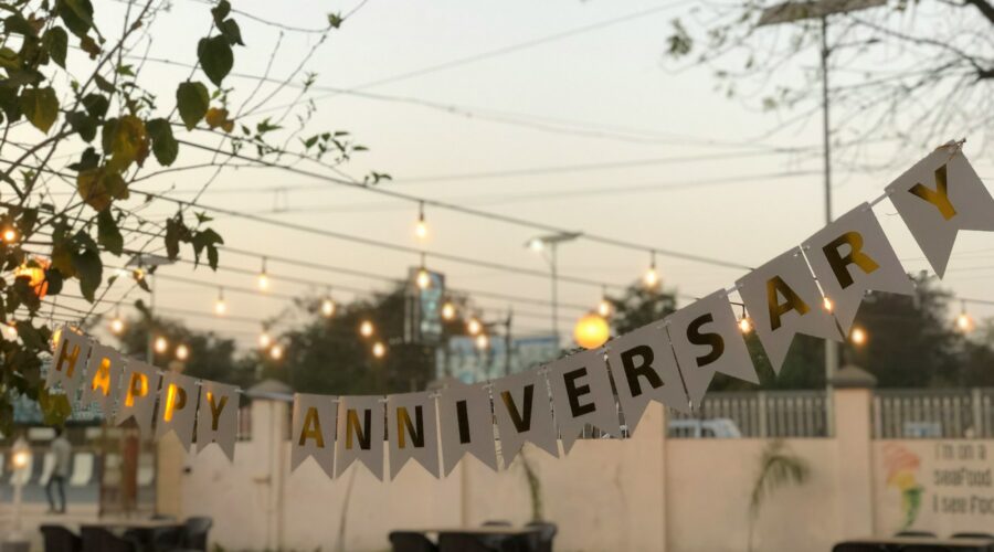 a party banner hanging over a table in a restaurant
