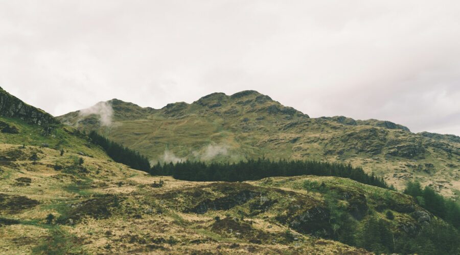 green mountain under cloudy sky
