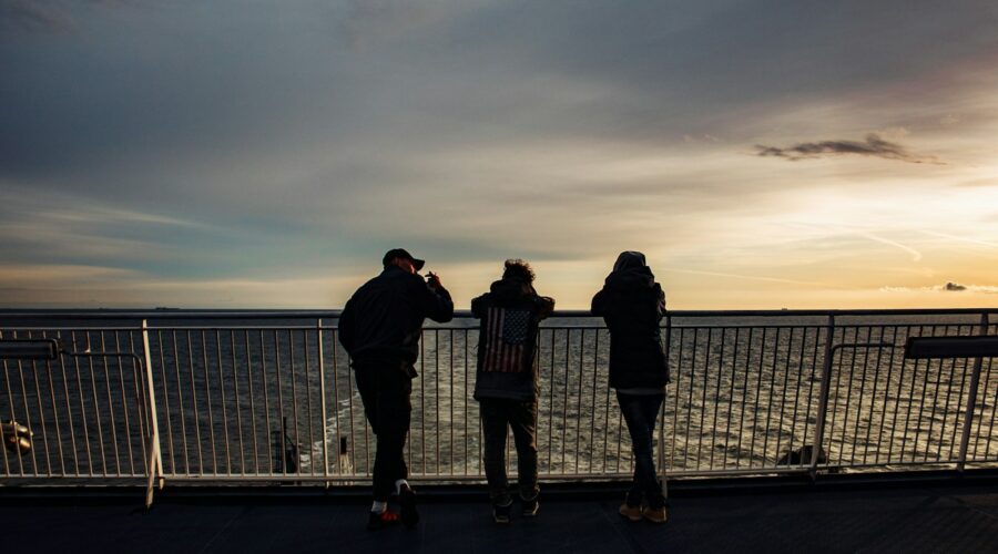 a group of people stand on a bridge