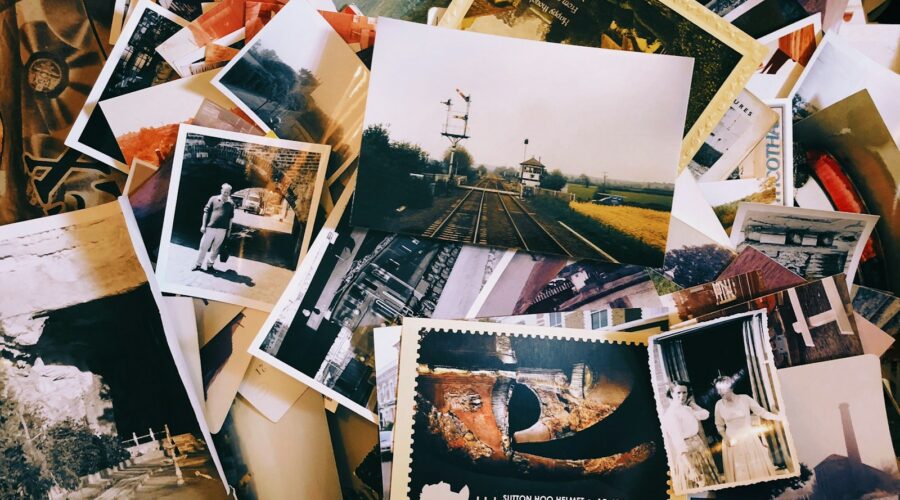 a pile of old photos and postcards sitting on top of each other
