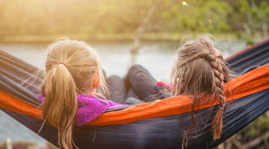 two women lying on hammock
