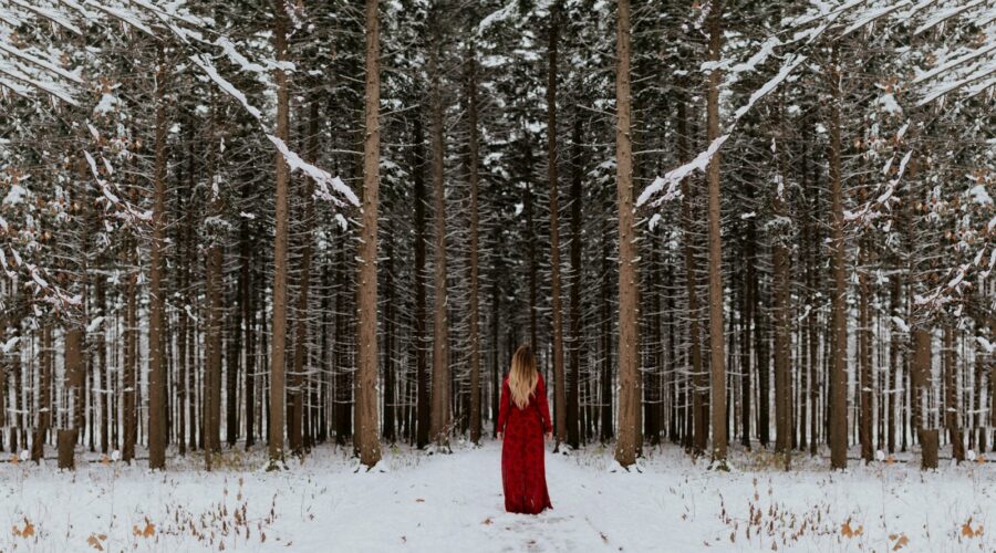 woman standing in front of forest
